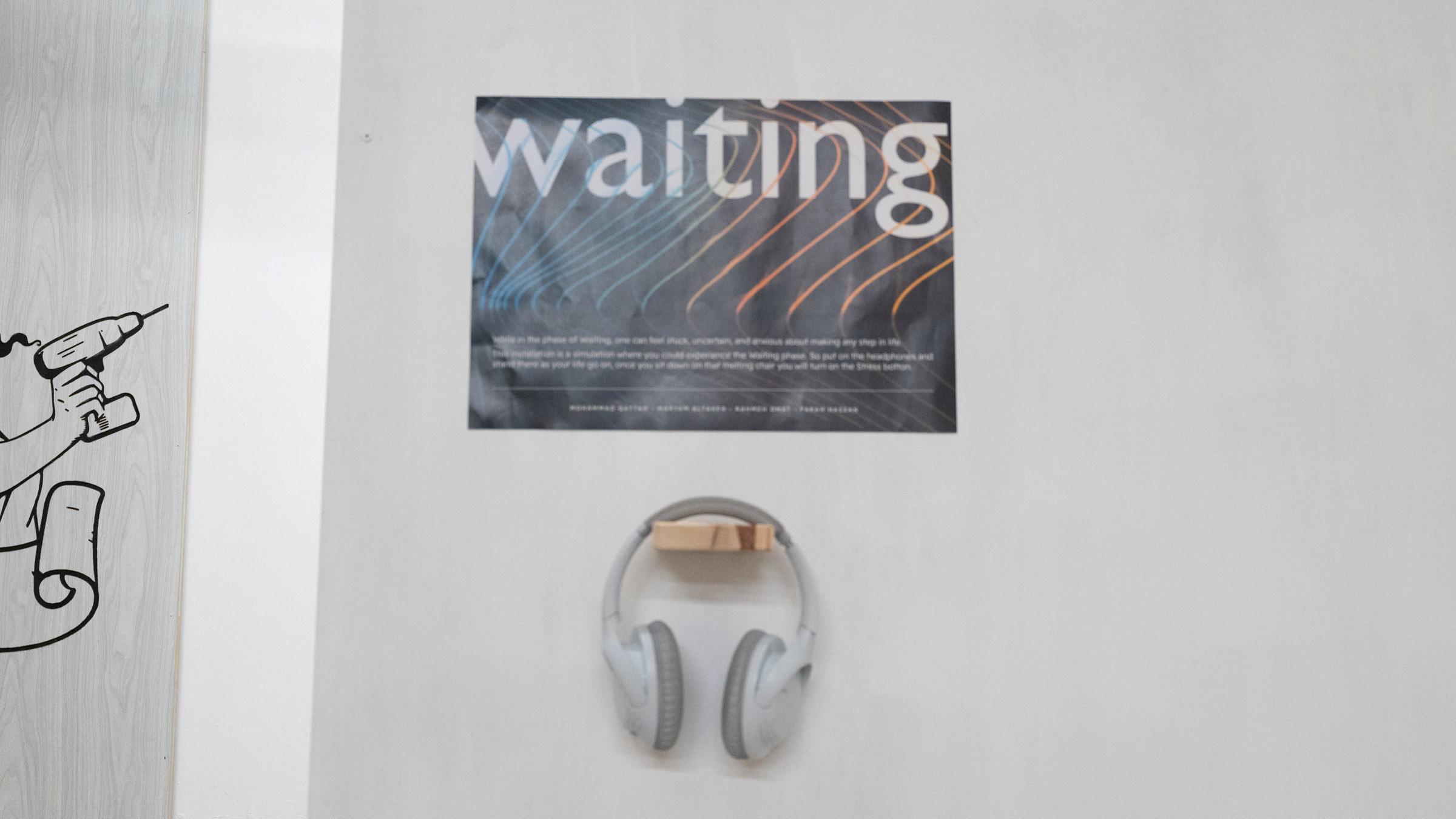 Dark poster with rainbow diagonal lines, large lettering reading waiting at the top, a pair of white headphones hanging under.