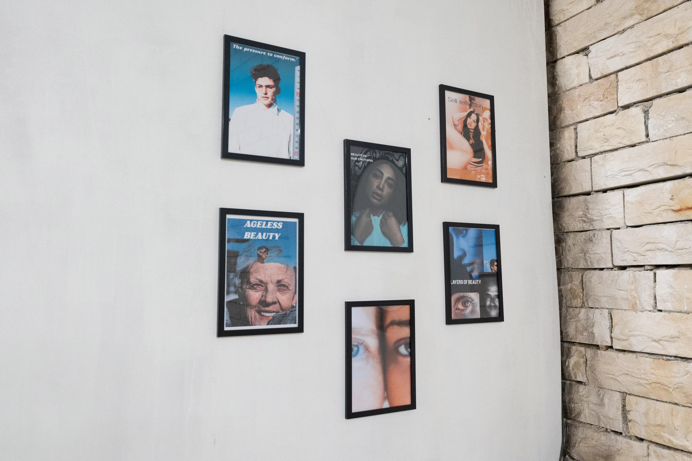 Close-up of framed images of individuals, mostly depicting faces and upper body hanging on the wall in rows of three.