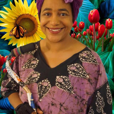 African-american woman in a purple headdress holding a cane over a colorful background  of plants and butterflies