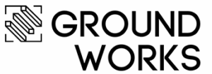 A black and white logo featuring an inked geometric design with three diagonal lines in a viewfinder box, next to the bold text "GROUND WORKS" in uppercase letters.