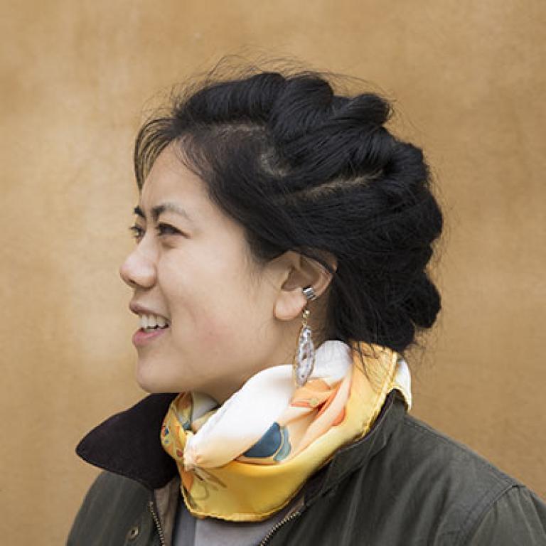 headshot of composer Julie Zhu against a yellow background